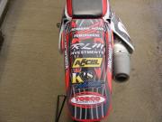 Another dirt bike tail wrapped with General Formulations Motomark with various sponsor logos on it