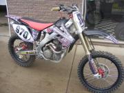 Another dirt bike with General Formulations MotoMark with an advertisement for Michigan Honda on it