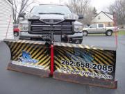 Another snow plow wrapped with General Formulations MotoMark advertising for RC property works