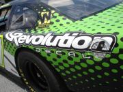 Another race car wrapped in General Formulations Automark with an advertisement for Revolution Decal