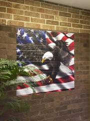 brick wall decal of bald eagle over american flag